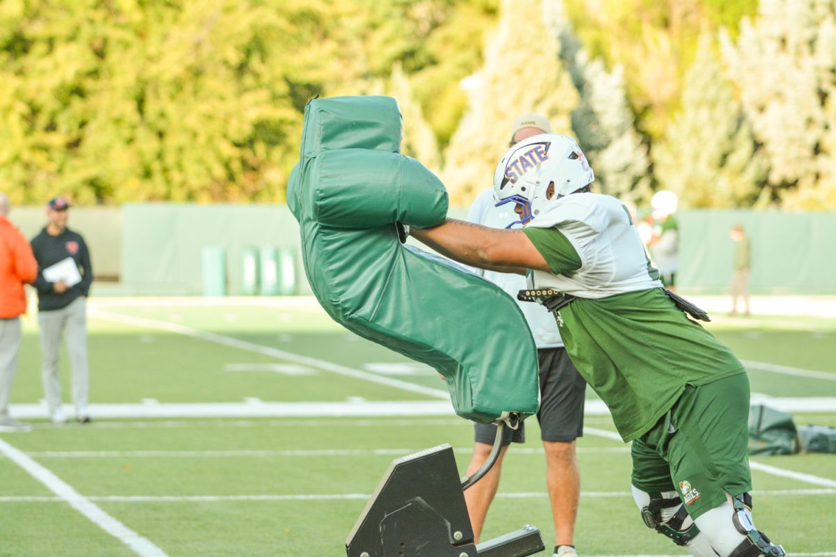 CSU linebacker practicing pushing people during morning practice. 