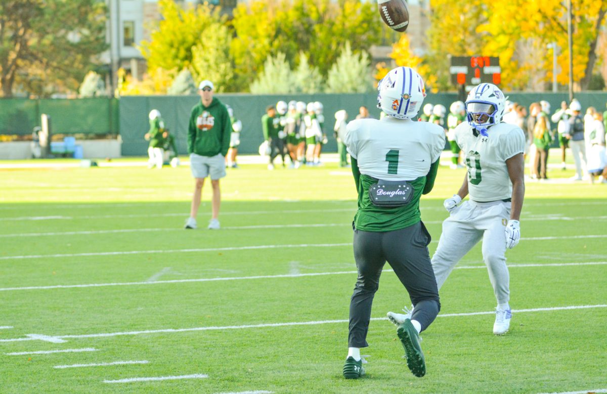 CSU football player catching a ball during a drill. 