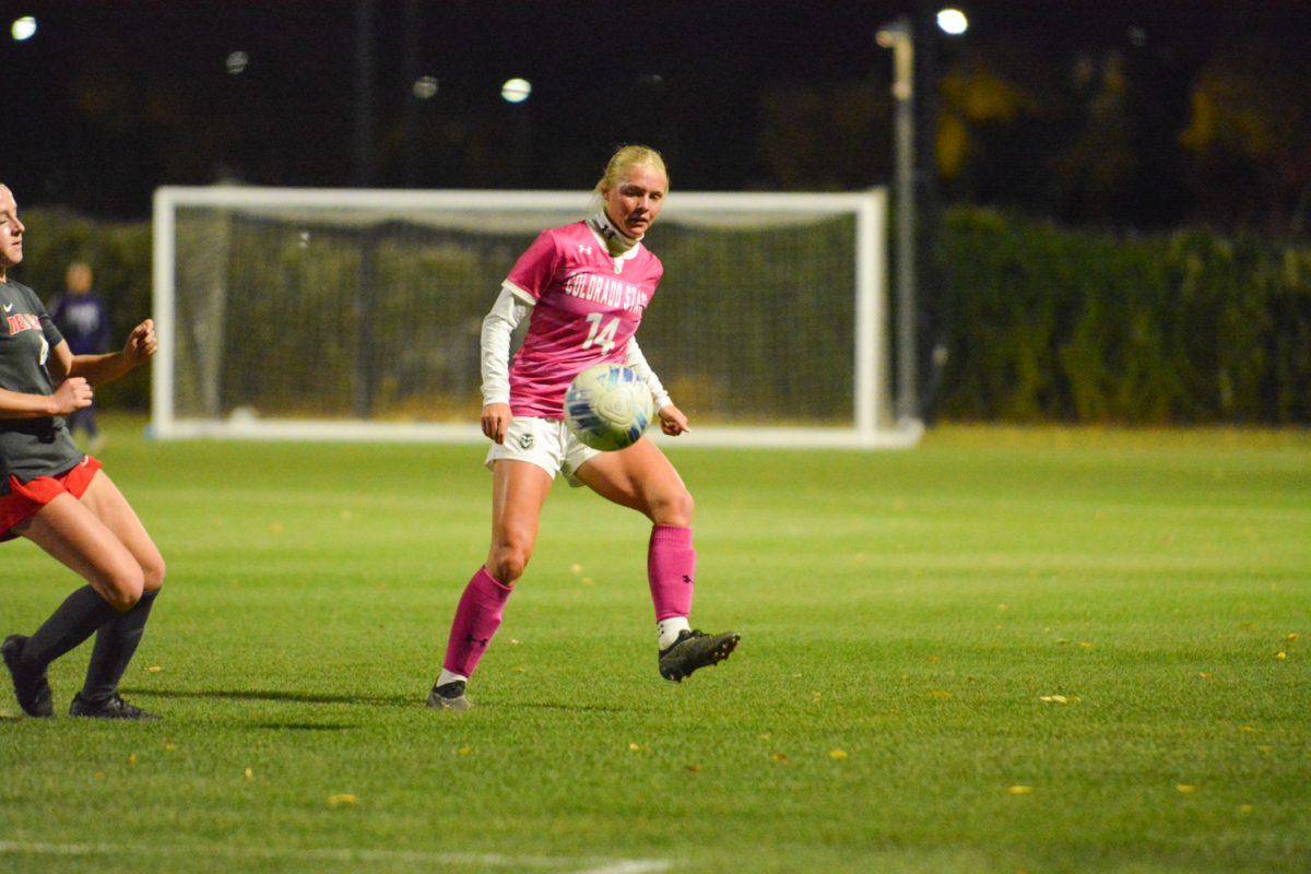 Girl in pink jersey kicking ball