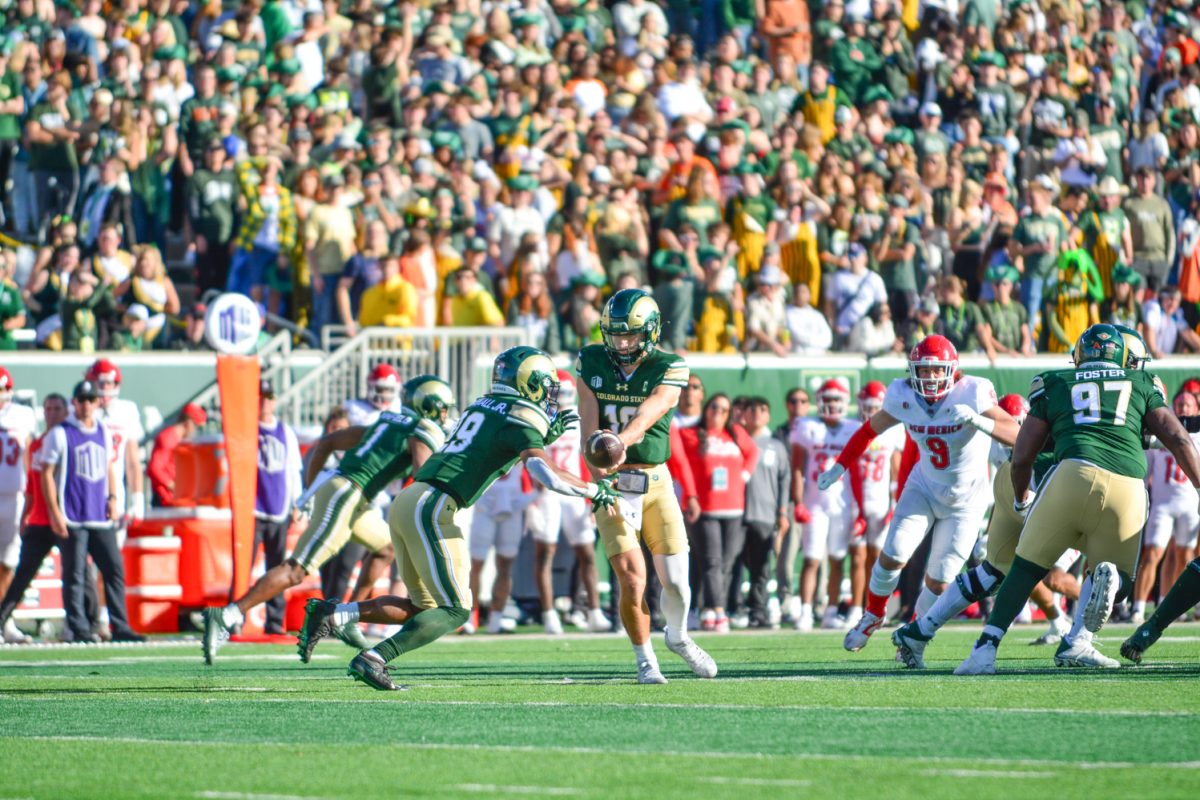 Football player passing the ball to teammate