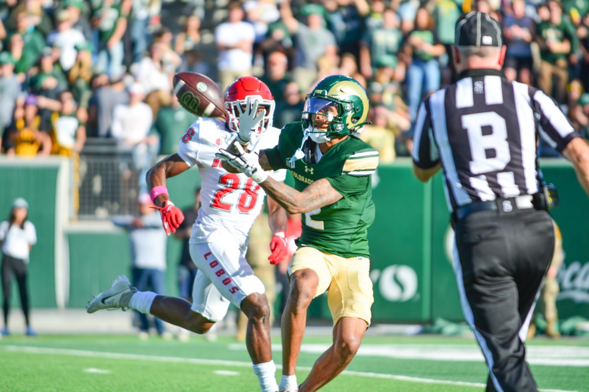 Football player in green jersey catching a football