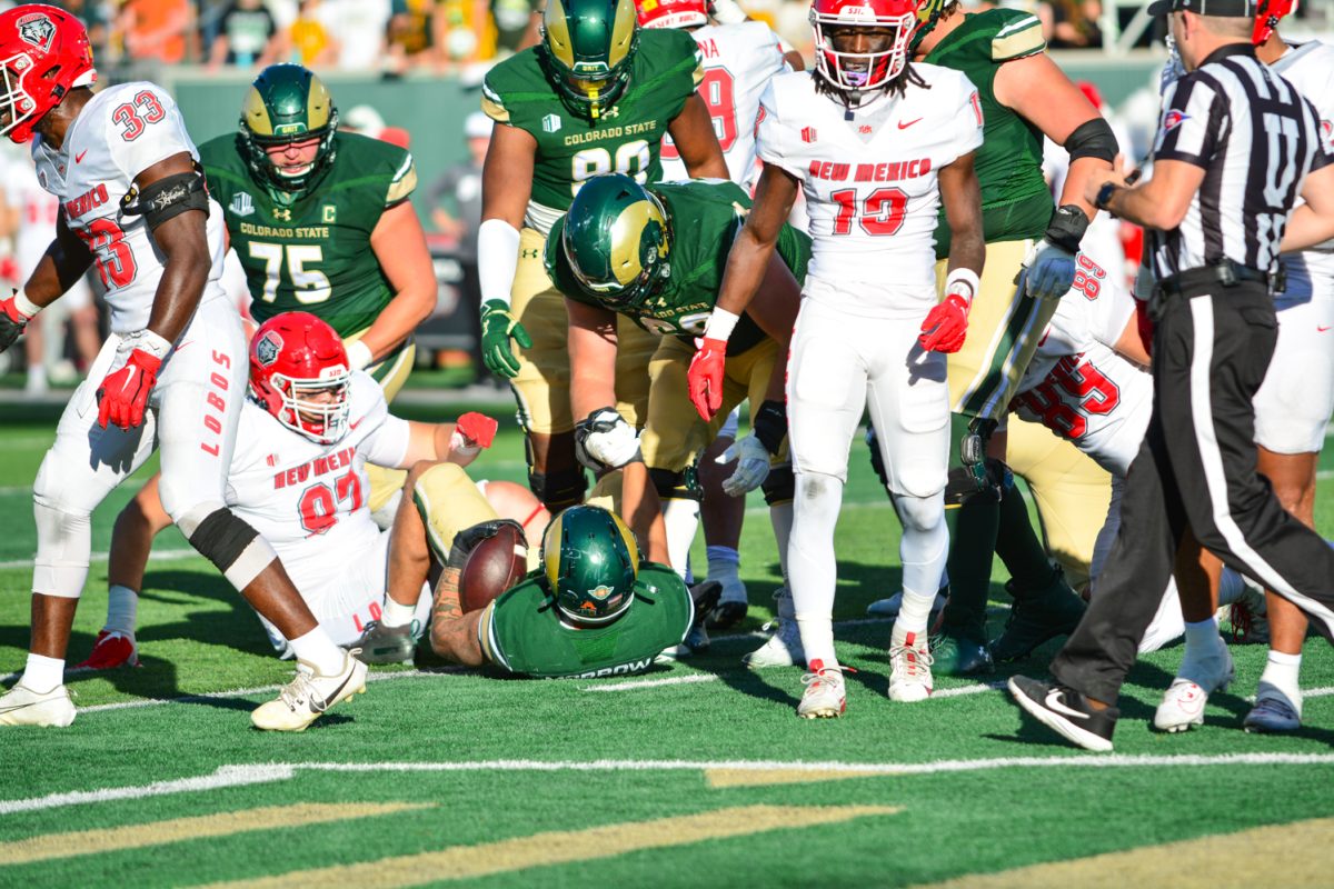 A teammate in green jersey helps another teammate in green jersey