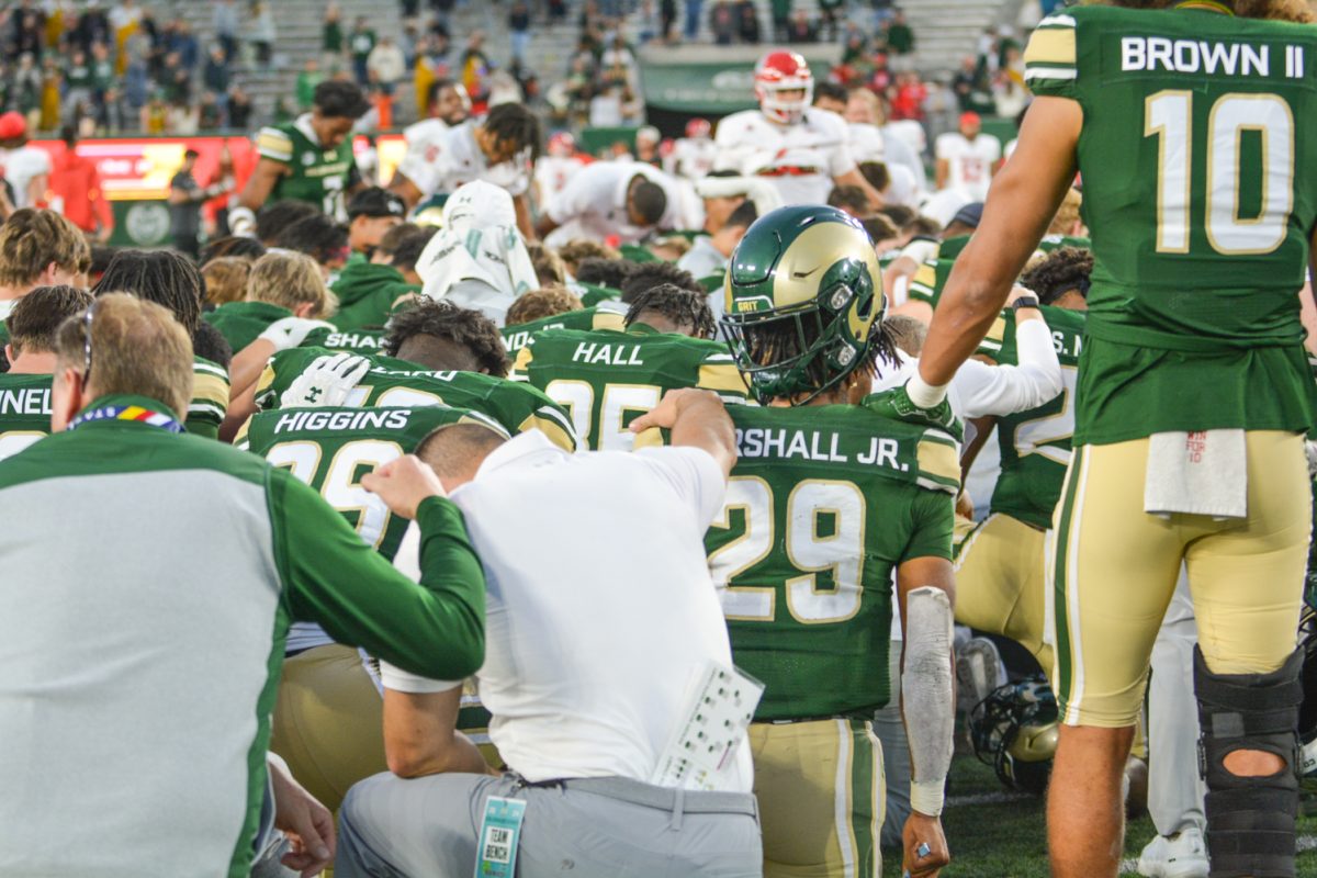 A football team bowing their heads