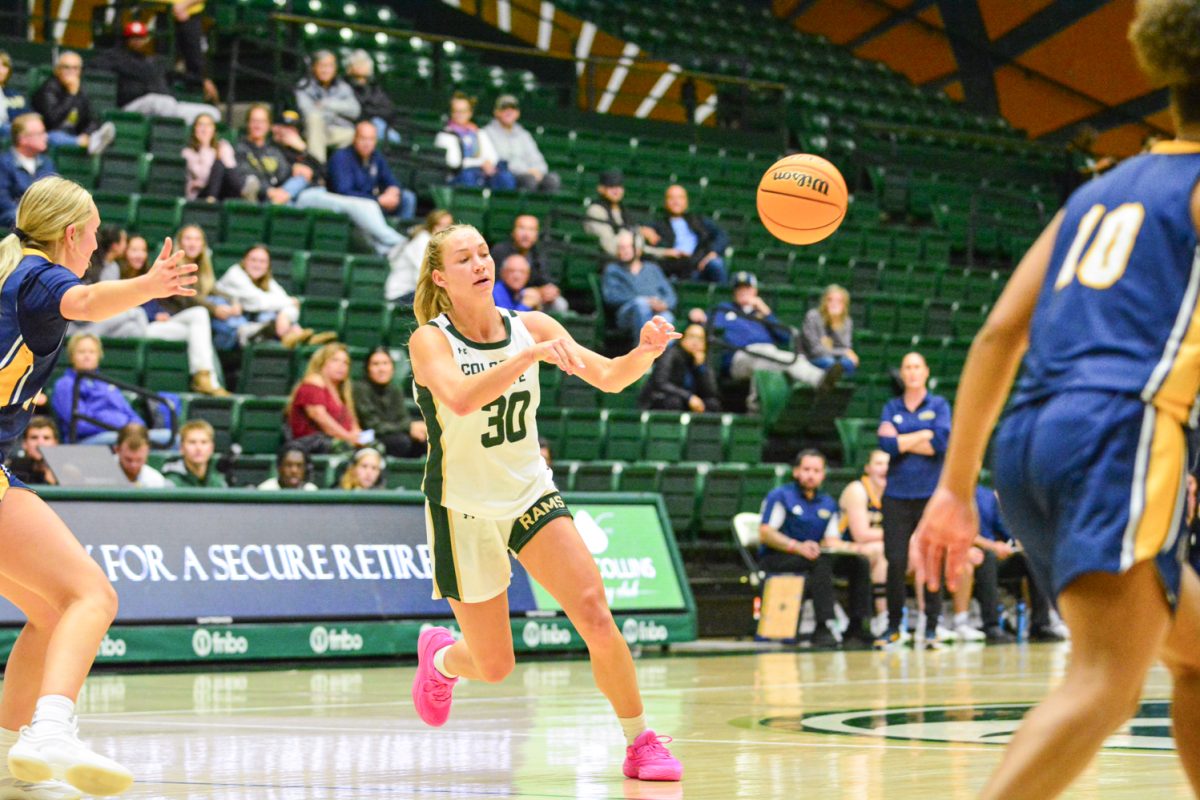 Girl in green and white jersey passing the ball