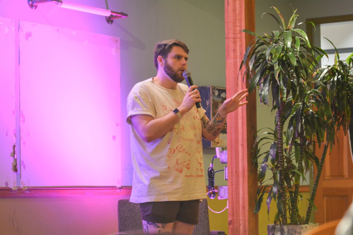 A speaker holding a microphone looking at the crowd