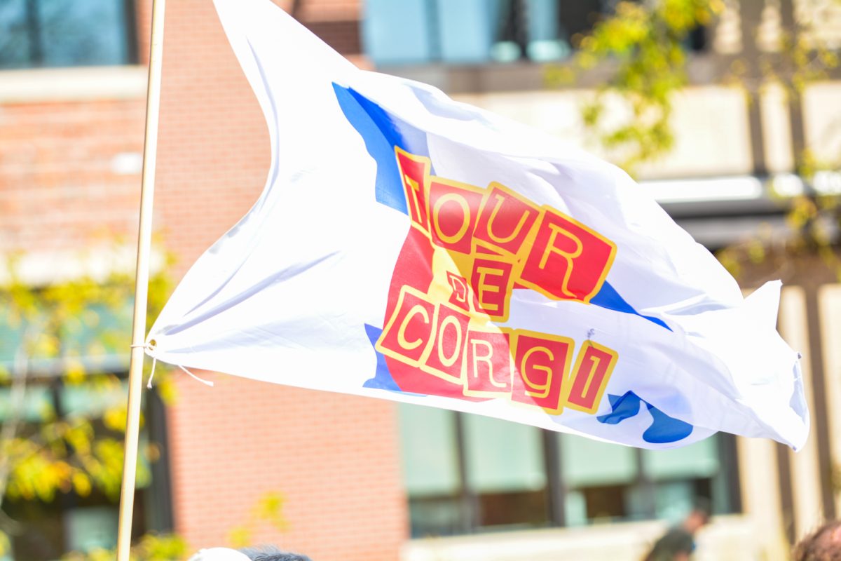 A Colorado flag with the words Tour de Corgi on it in red and yellow letters.