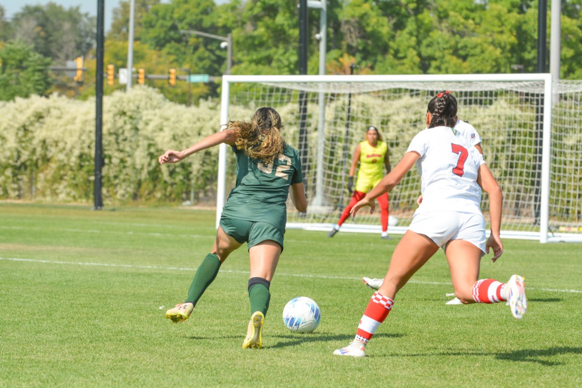 two soccer players fighting over the soccer ball