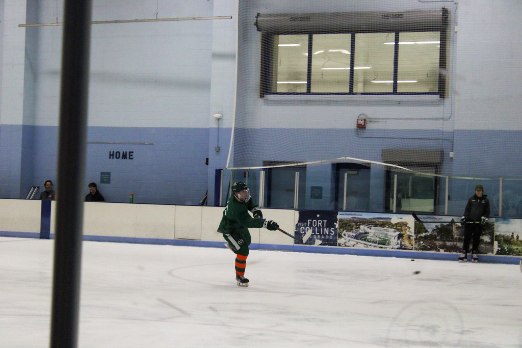 A Colorado State hockey player (15 maybe? IDK) shoots the puck at the goal during practice Oct. 1.