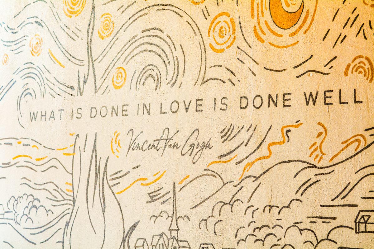 A mural stating "What is done in love is done well"