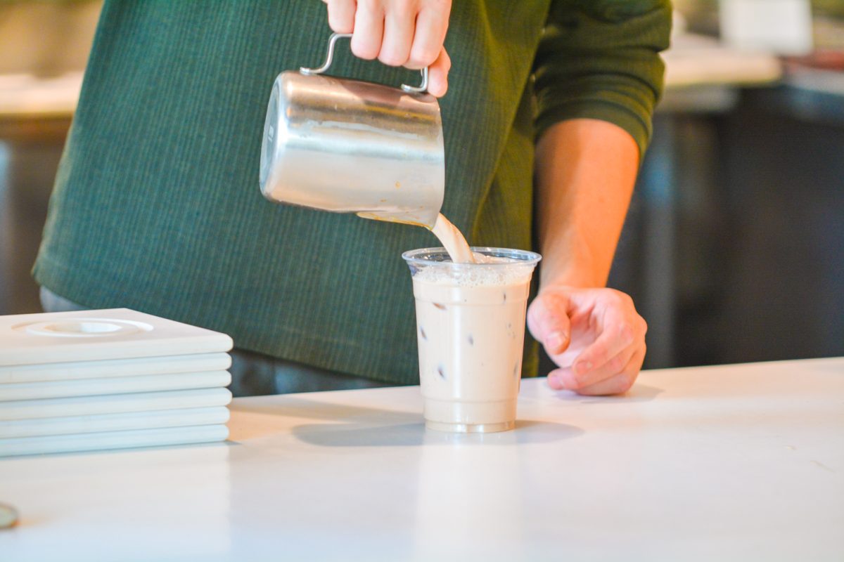 A Chai drink being poured into a cup