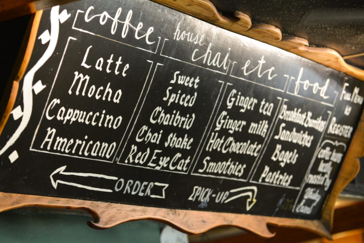 An order board with multiple coffee and chai options