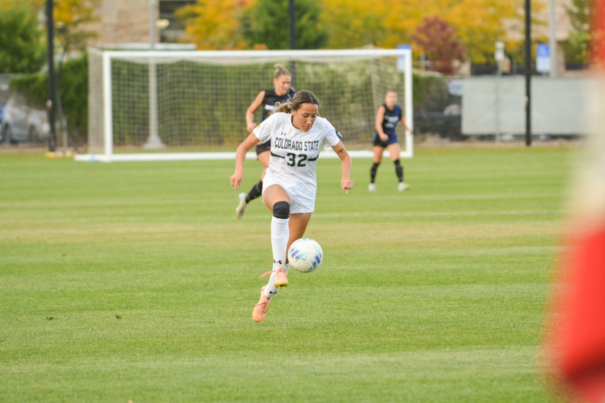 A soccer player kicking a soccer ball