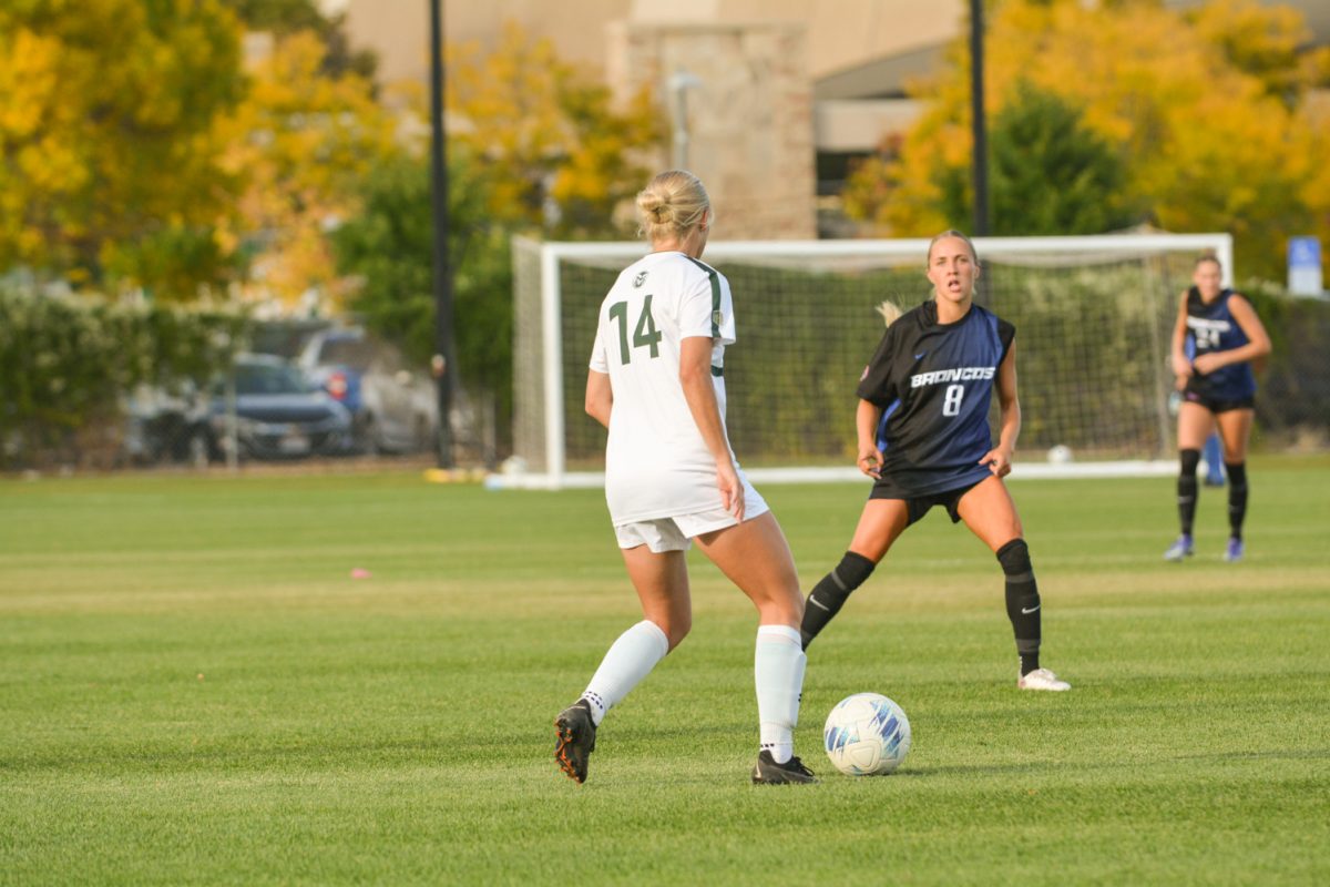 Katy Coffin (#14) running with the ball trying to avoid a Boise State player Oct. 10. Colorado State University ties with Boise State 1-1.