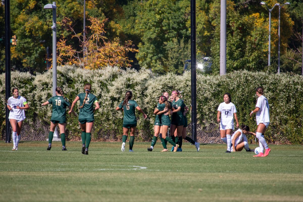 A soccer team cheering after scoring a goal.