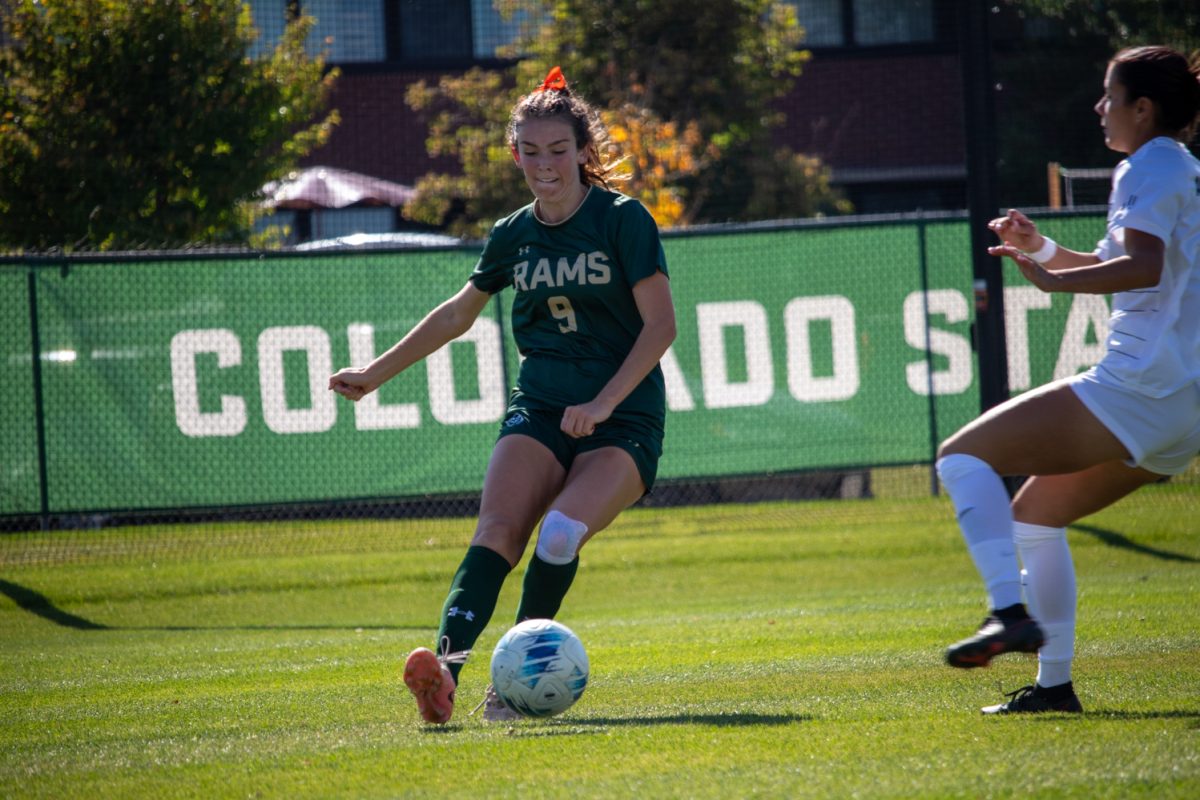 A person kicking a soccer ball.