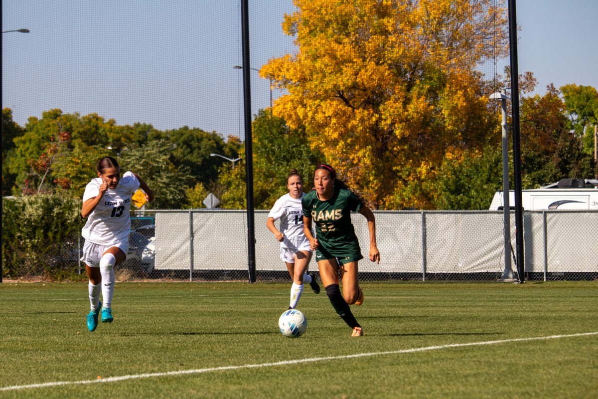 A soccer player kicking the ball downfield.