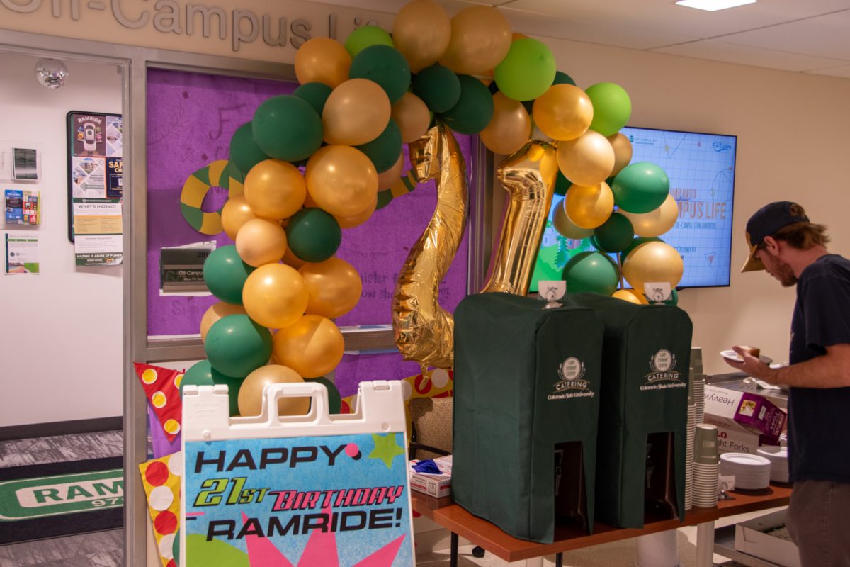 Gold and green balloons with the gold balloon numbers 2 and 1. Students get cake and coffee.