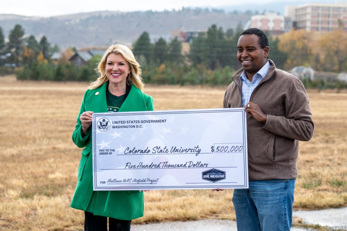 Colorado State University President Amy Parsons and Colorado State Representative Joe Neguse hold a cerimonial check for $500,000 at Christman Airfield in Fort Collins Colorado   Oct. 29 Rep. Neguse presented CSU with $500,000 thousand doallrs to renovate the airfield and aid in research of drones for use in emergency services.