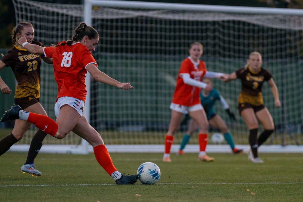 A soccer player winds up for a kick.