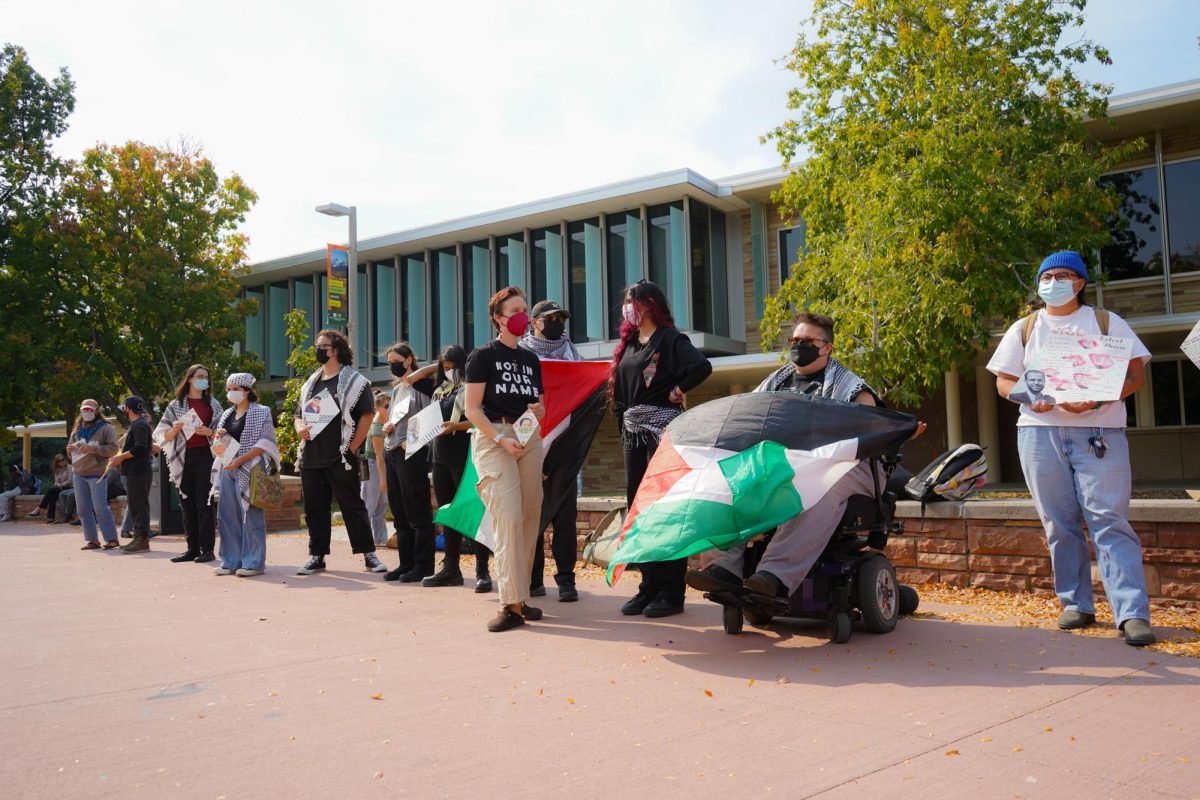 Ella Smith and members of Students for Justice Palestine on The Plaza Oct. 7 take part in the Walk Out For Palestine demonstration. The demonstration was organized to mark one year since the start of the Israel-Hamas war. 