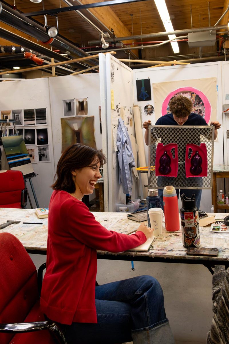 Ariel Sophabmisay laughs with fellow classmates, giving humor and life to their painting capstone class at CSU on Oct. 21. The class works together to critique and brainstorm each other's art and by having moments like these, they not only are able to be honest in their critiques but also grow closer together as classmates. 