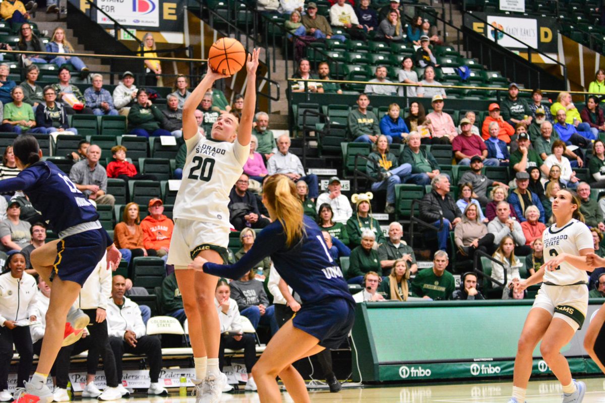 A player in a green and white jersey jumping up.