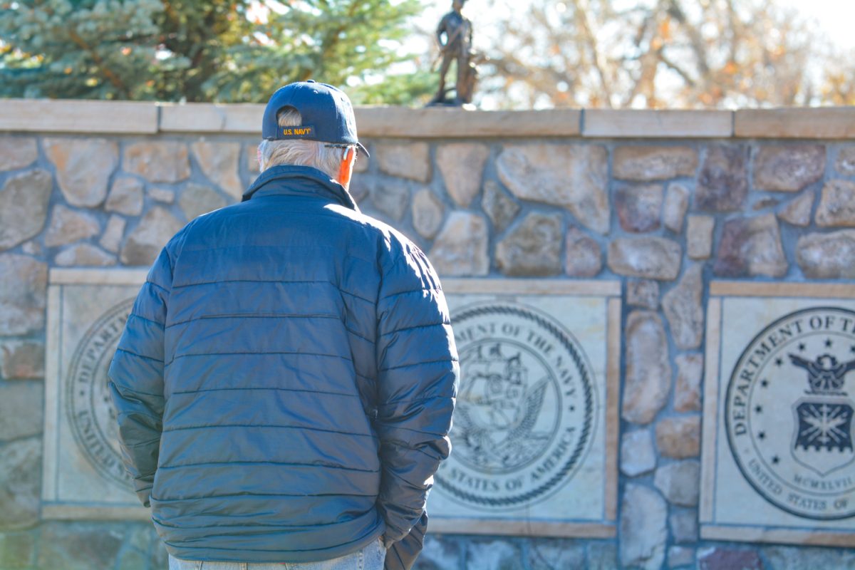 Steve Jetter contemplates plaques of the four branches of military at Veterans Plaza in Fort Collins Nov. 11. "My dad was in the Marine Corps in World War II," Jetter said. "I spent three years in Vietnam."