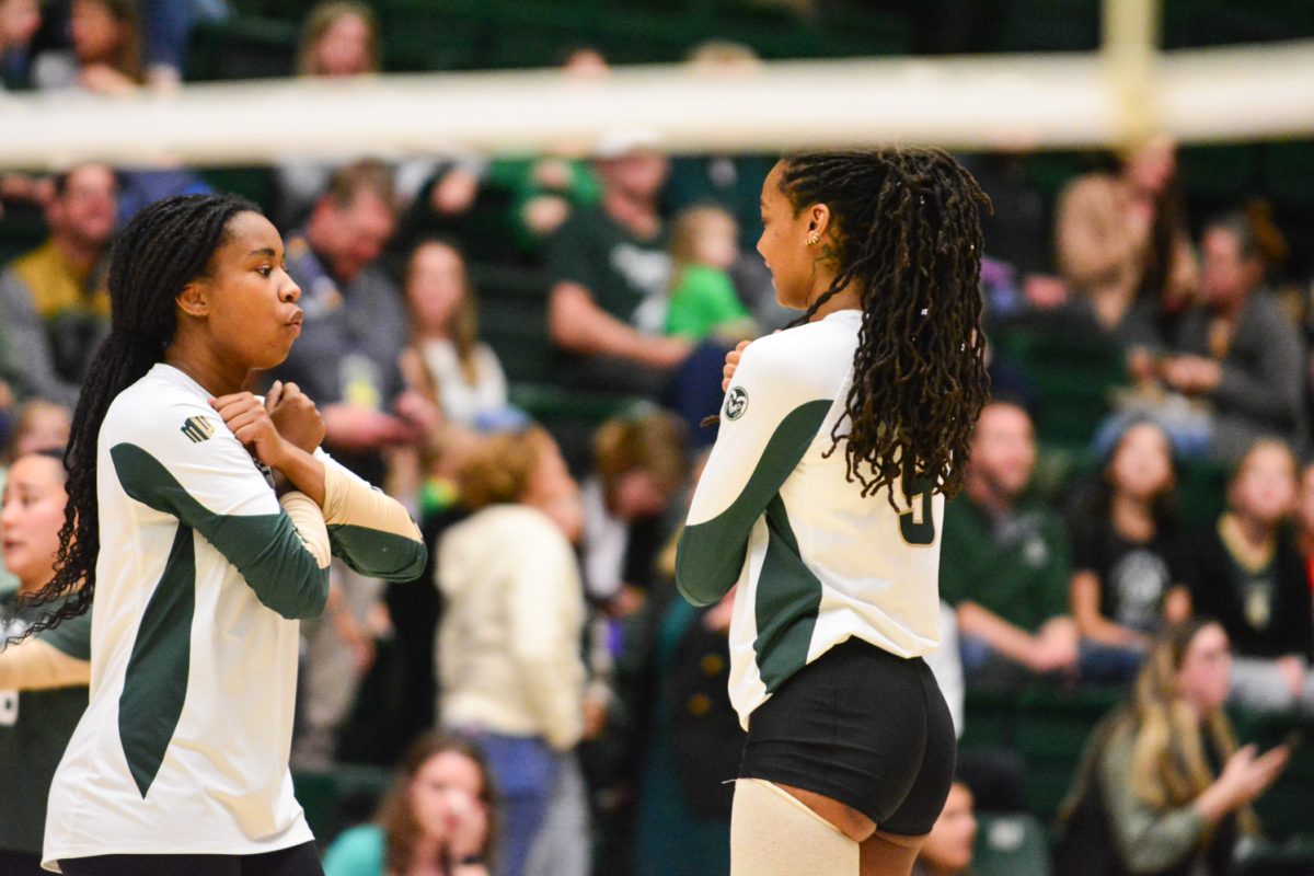 Two players in a green and white jerseys.