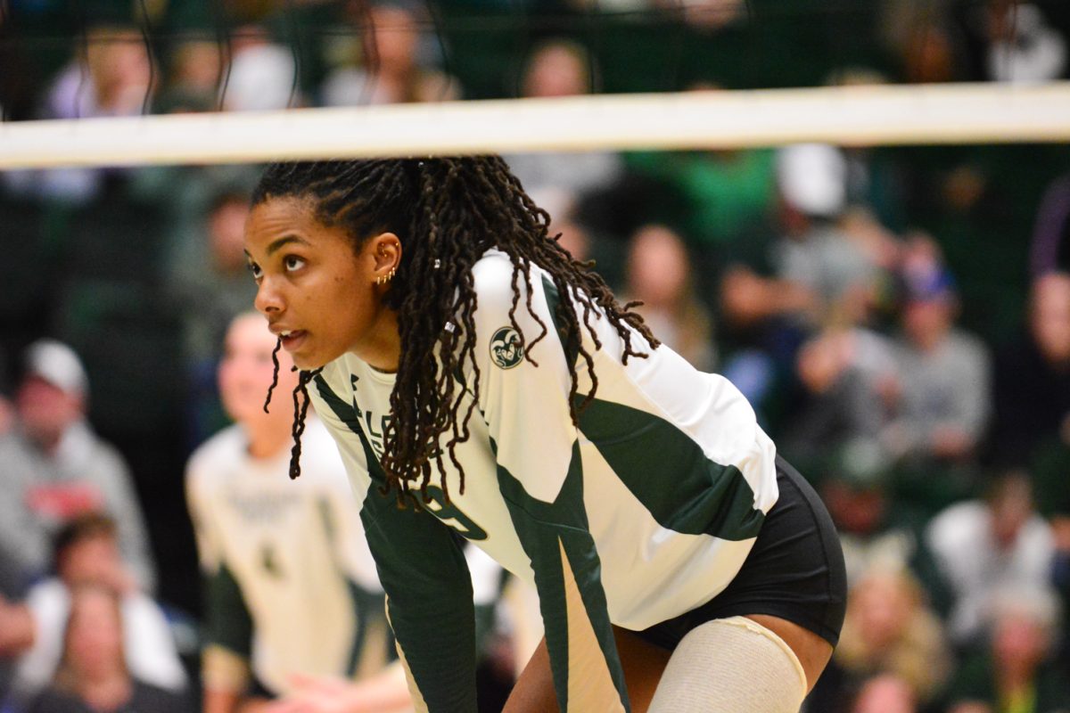 A player in a green and white jersey looking at the other team