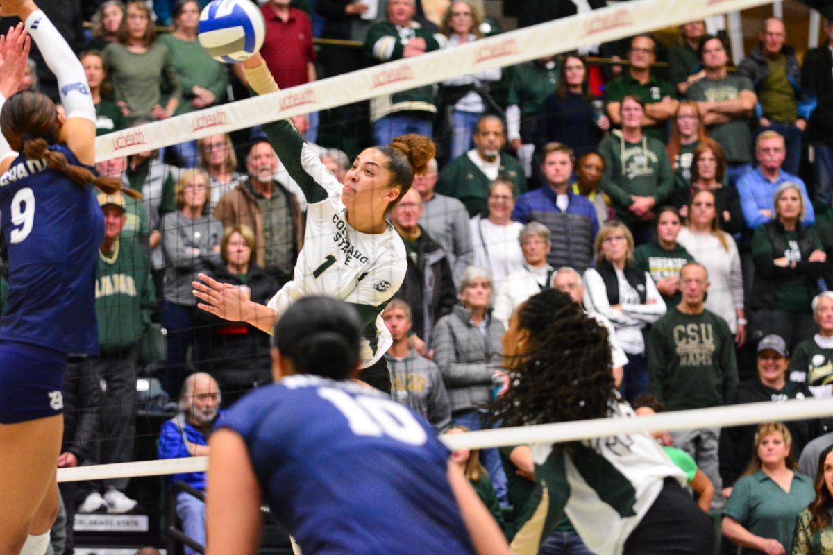 A player in a green and white jersey striking the ball.