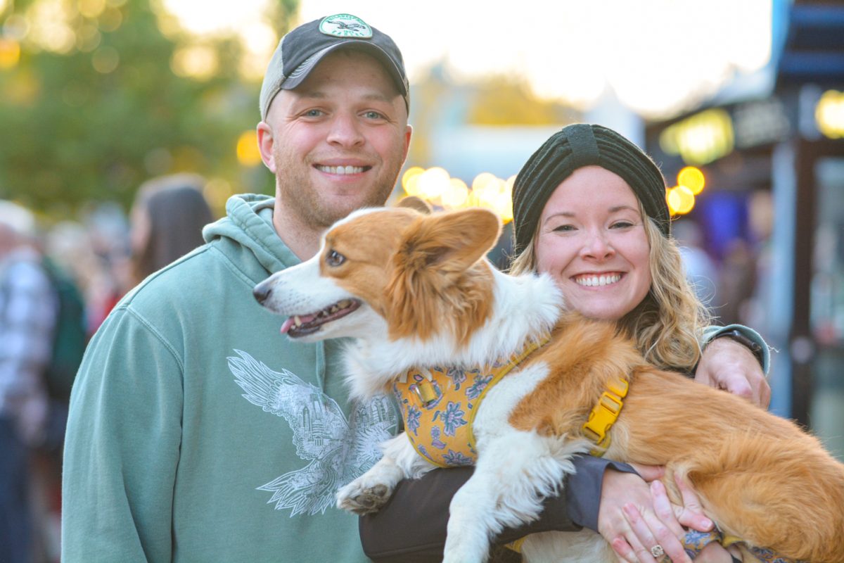 A couple holding a dog