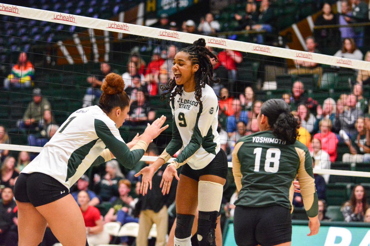 Two girls in green and white jerseys celebrating