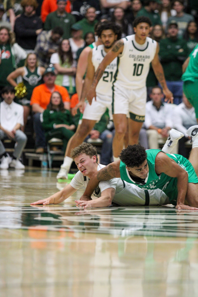 Bowen Born (13) is knocked over by a North Dakota player while trying to steal the ball.