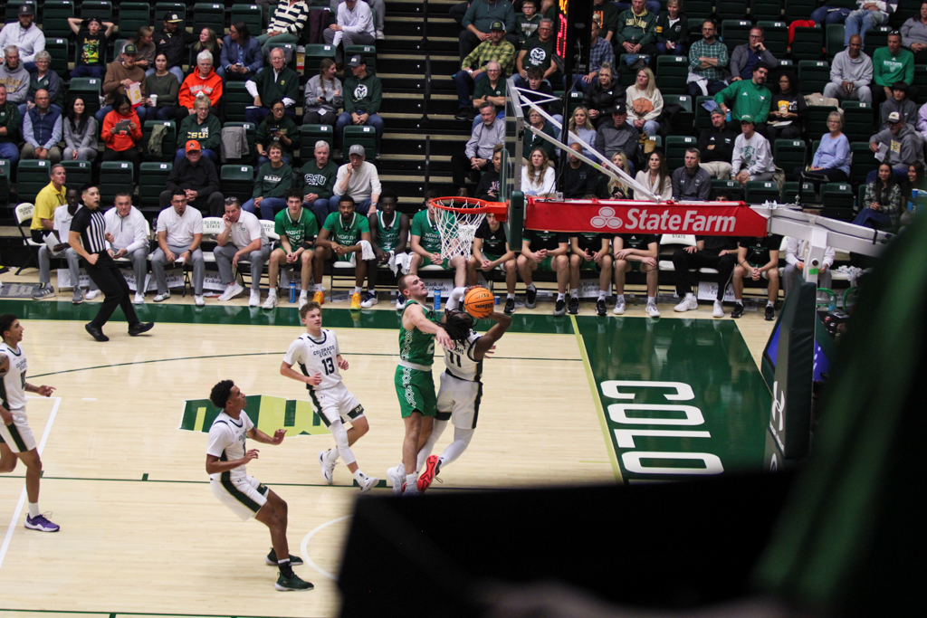 Keshawn Williams (11) shoots a two-pointer around a North Dakota player.