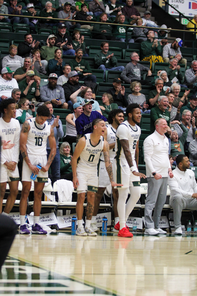 The Colorado State bench celebrates after their teammate made a shot.