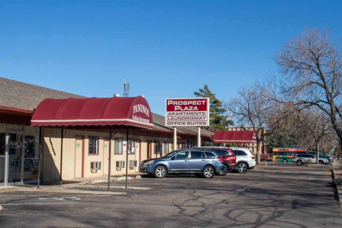 The outside of a building with a restaurant, laundromat, and offices.