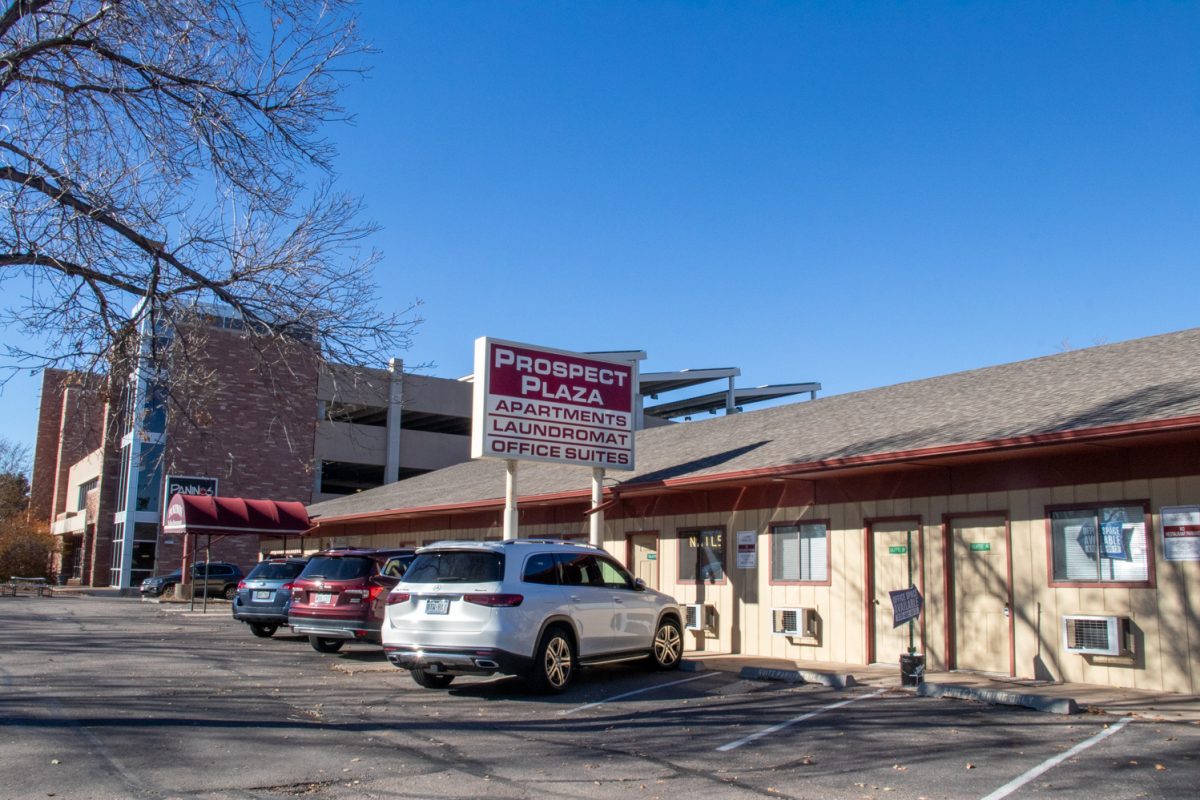 The outside of a building with a restaurant, laundromat, and offices.