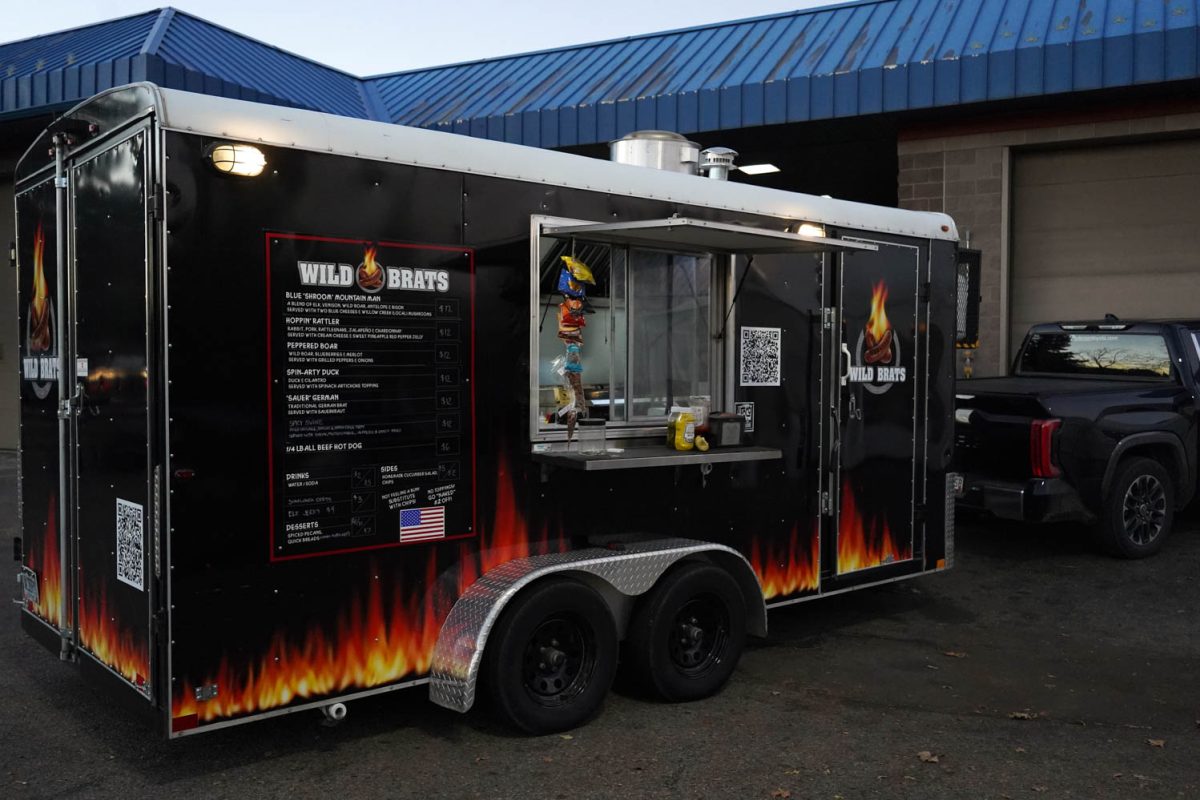 Image of a black food truck with flames painted across the bottom.