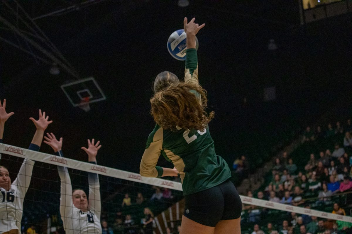 A volleyball player hits the ball.