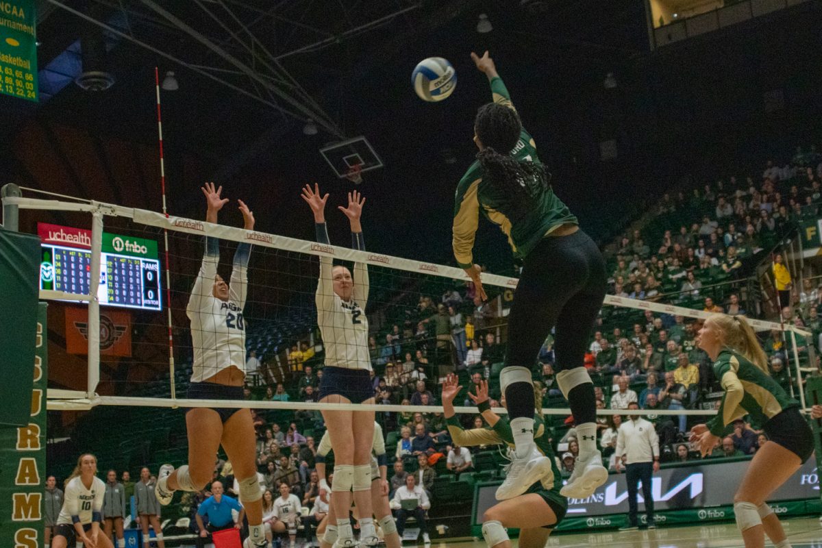 A volleyball player hits the ball.