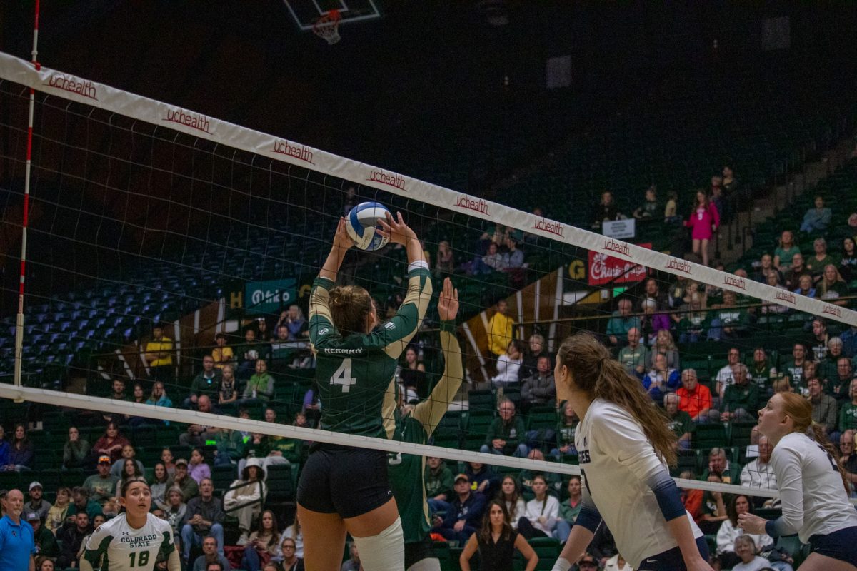A volleyball player sets the ball.