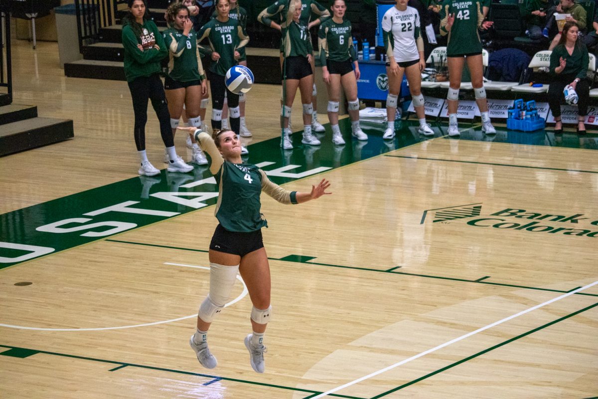 A volleyball player serves the ball.