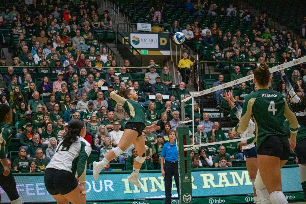 A volleyball player hits the ball.
