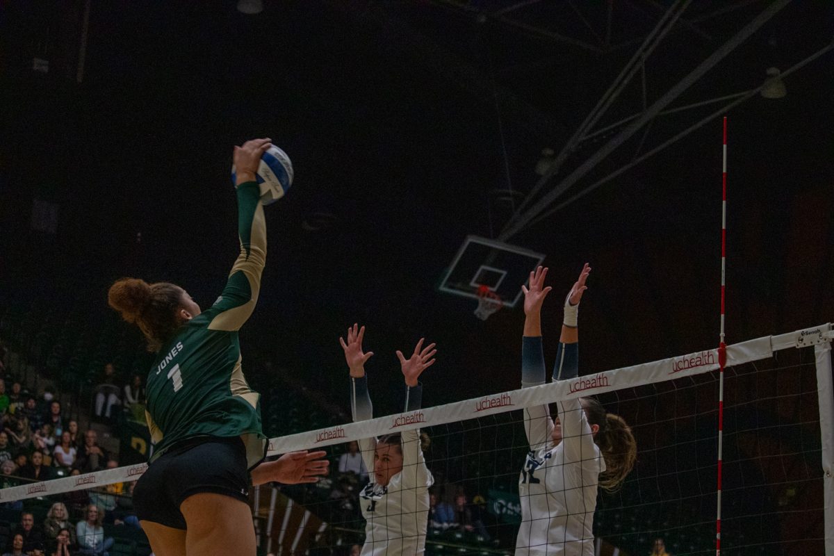 A volleyball player hits the ball.