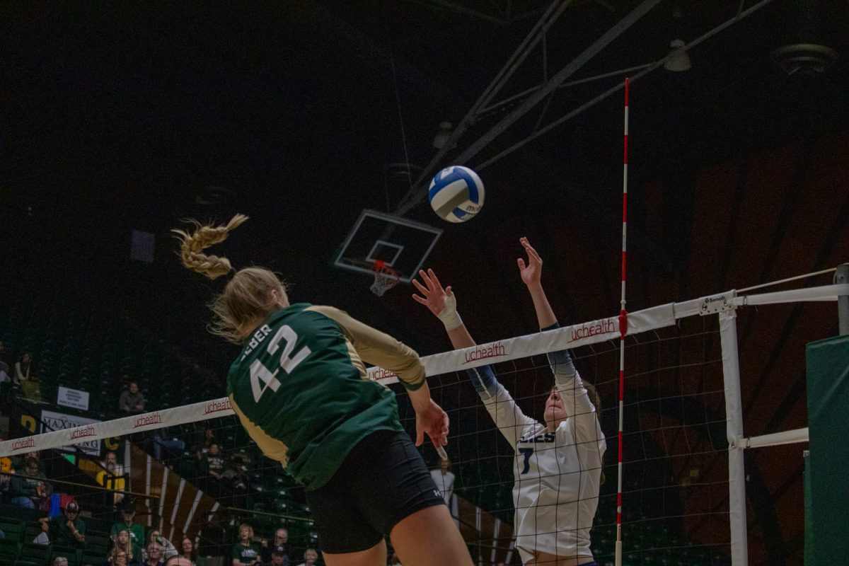 A volleyball player hits the ball.