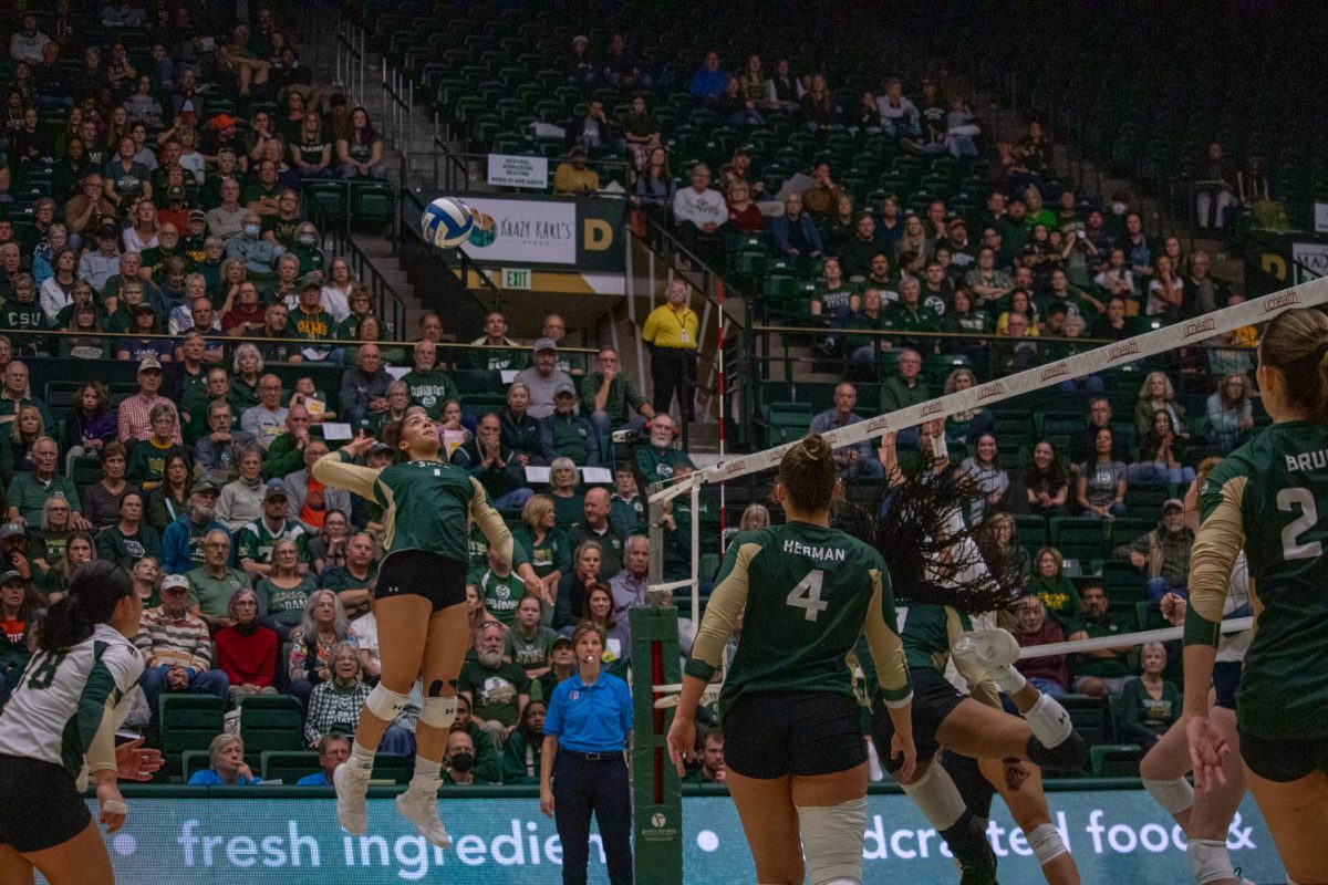 A volleyball player hits the ball.