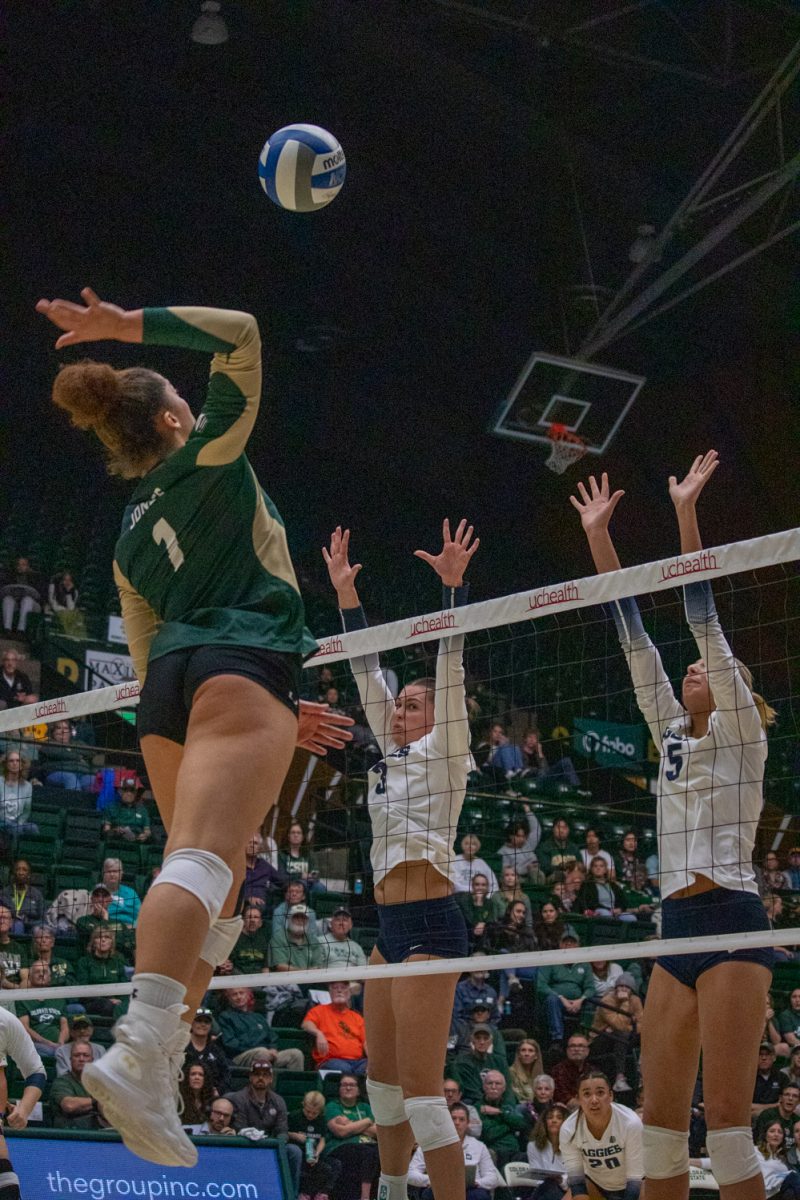 A volleyball player hits the ball.