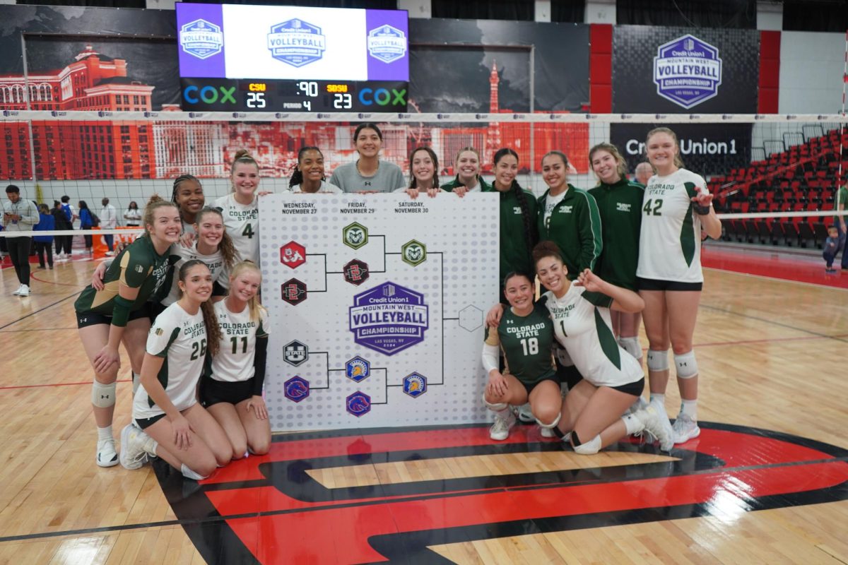 Colorado State volleyball celebrates after beating San Diego State Nov. 29. The Rams placed a sticker on board to mark them as one of the finalists in the Mountain West tournament. 