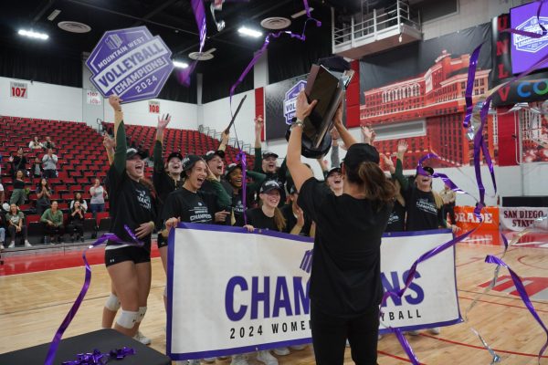 Colorado State University volleyball coach Emily Kohan displays the trophy to team after winning first in Mountain West tournament Nov. 30. CSU beat San Jose State 3-1. 