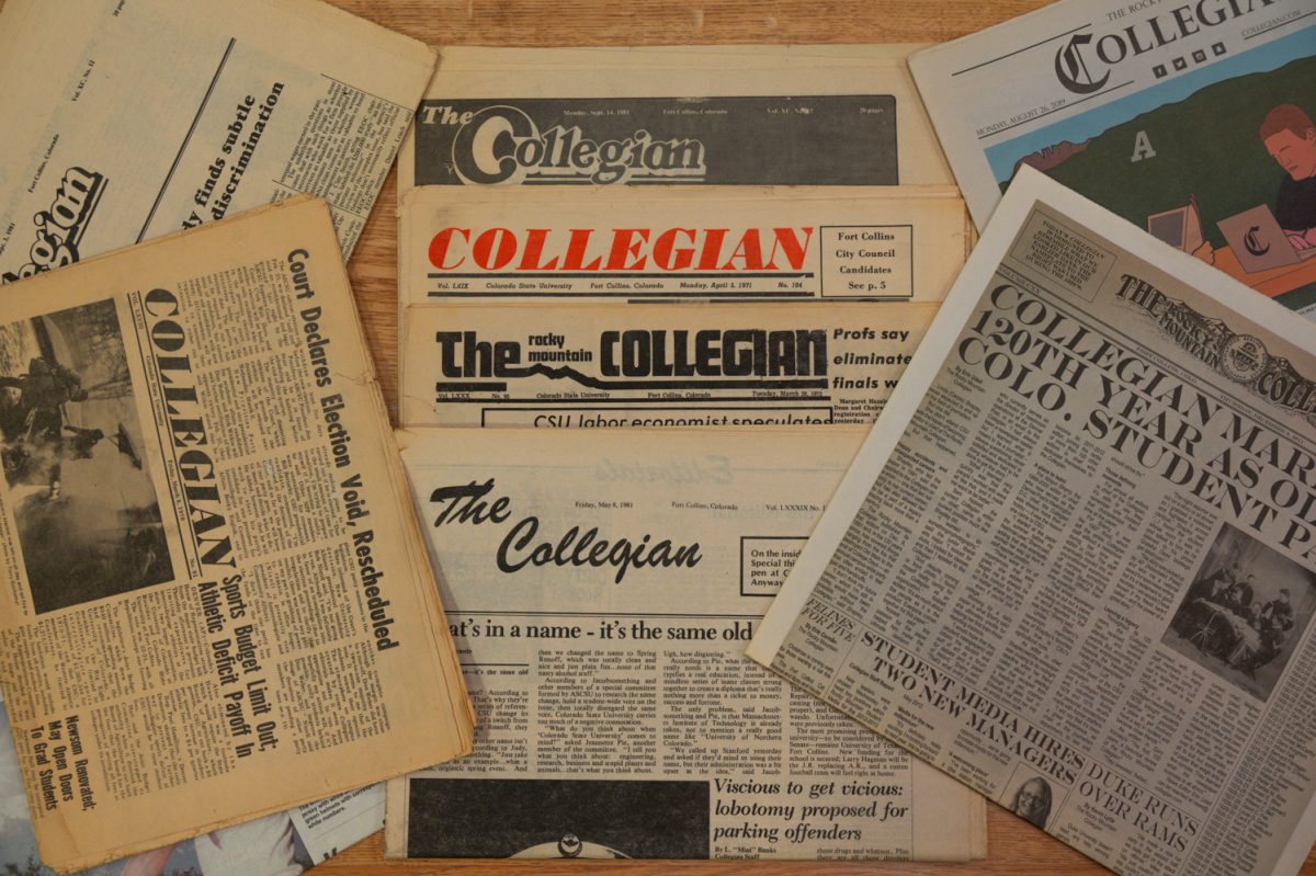 Several old newspapers from The Collegian archives scattered on a conference room table Dec. 2, 2024.